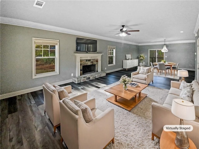 living room featuring a fireplace, wood-type flooring, ceiling fan, and ornamental molding