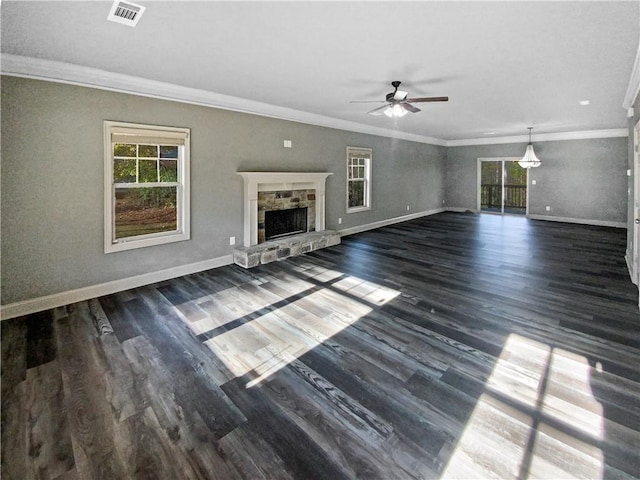 unfurnished living room with a stone fireplace, ceiling fan, dark hardwood / wood-style floors, and ornamental molding