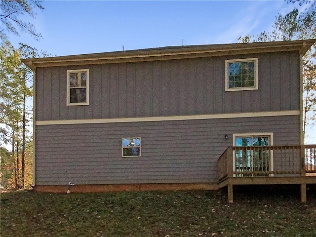 back of property featuring a wooden deck