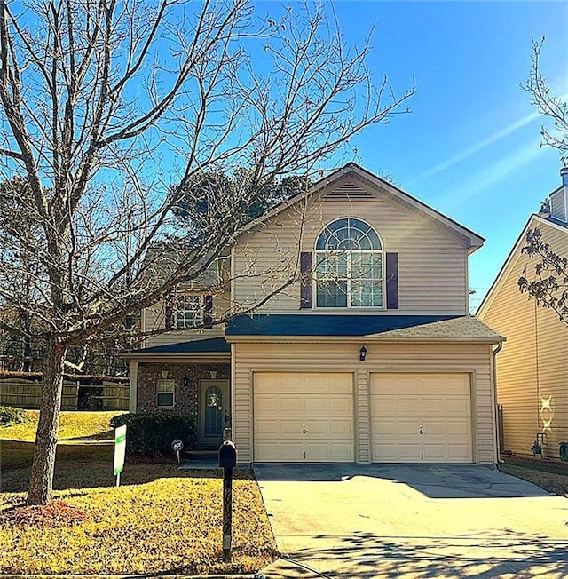 front facade featuring a garage and a front yard