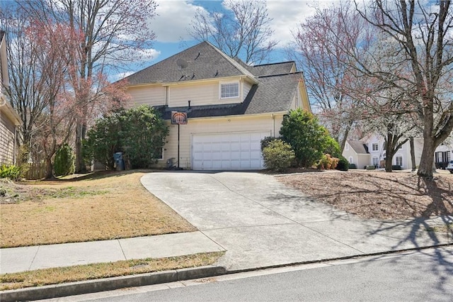 view of front facade with a front yard, a garage, driveway, and roof with shingles