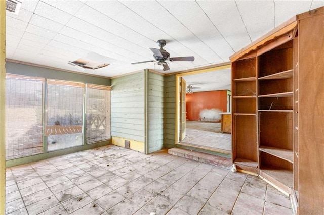 unfurnished sunroom with ceiling fan