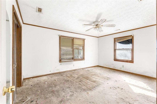 empty room featuring a textured ceiling, crown molding, and ceiling fan