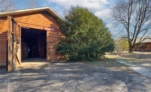 view of property exterior with an outdoor structure