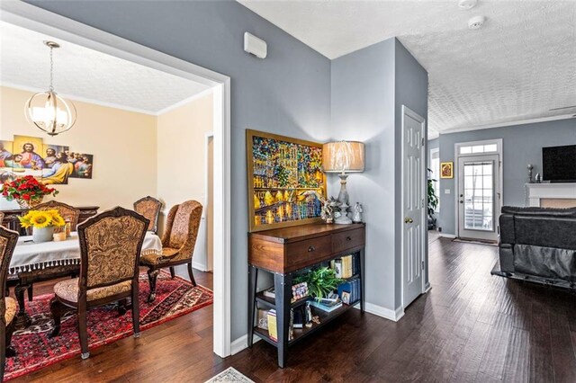 dining room featuring crown molding, baseboards, and wood finished floors