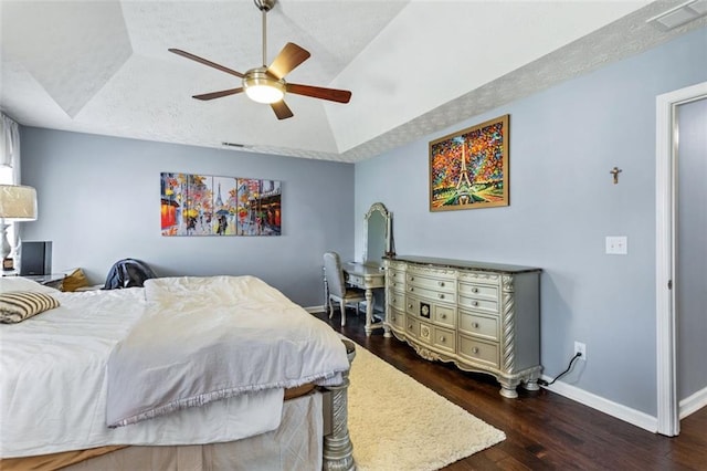 bedroom featuring a textured ceiling, wood finished floors, a ceiling fan, baseboards, and vaulted ceiling