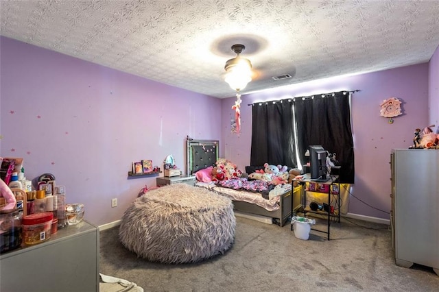 carpeted bedroom featuring visible vents, baseboards, and a textured ceiling