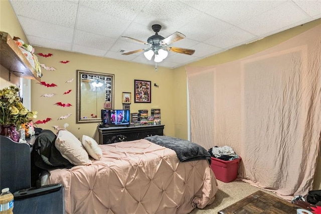 bedroom featuring ceiling fan and a drop ceiling