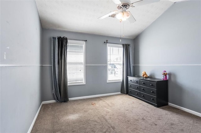 bedroom with lofted ceiling, ceiling fan, baseboards, and carpet flooring