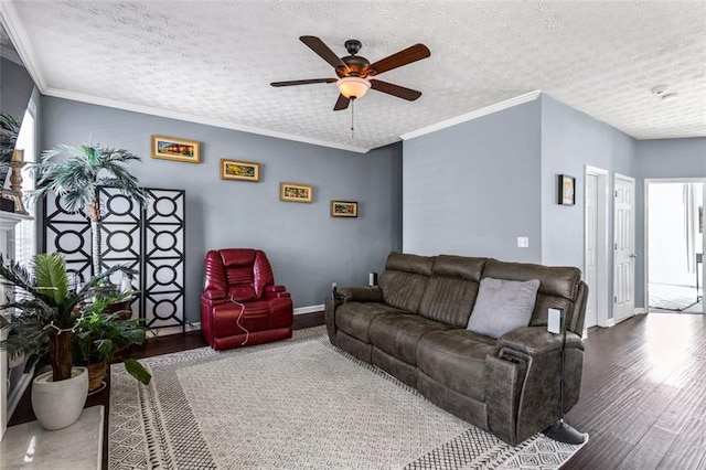 living room featuring a textured ceiling, ornamental molding, and wood finished floors