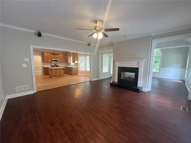 100 Hamilton Glen Ct, Fayetteville, GA 30215 - unfurnished living room with light wood-style floors, a ceiling fan, a high end fireplace, and crown molding