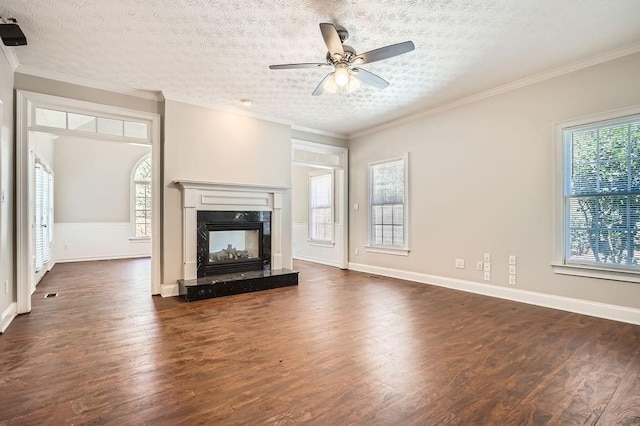 100 Hamilton Glen Ct, Fayetteville, GA 30215 - unfurnished living room featuring dark wood-style floors, a premium fireplace, ceiling fan, a textured ceiling, and crown molding