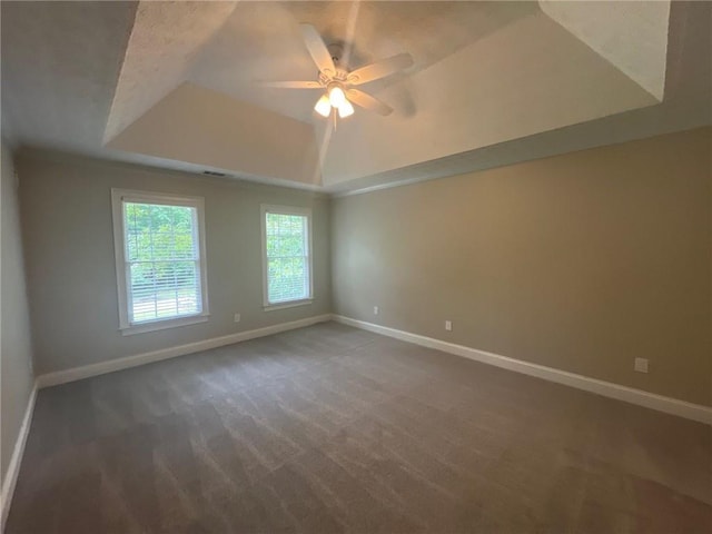 100 Hamilton Glen Ct, Fayetteville, GA 30215 - spare room featuring a tray ceiling, a ceiling fan, and dark carpet