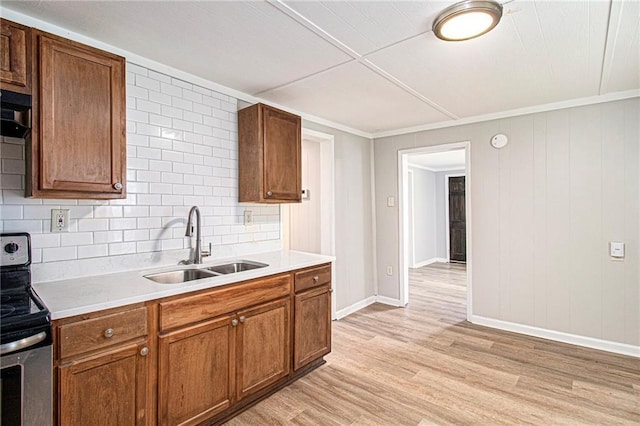 1186 Eastview Rd NE, Conyers, GA 30012 - kitchen featuring stainless steel range with electric stovetop, light wood finished floors, backsplash, and light countertops