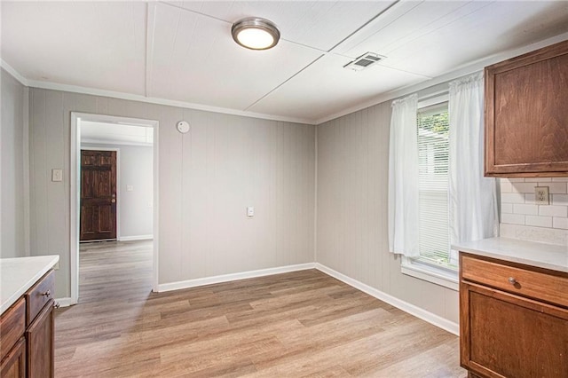 1186 Eastview Rd NE, Conyers, GA 30012 - unfurnished dining area featuring light wood-style floors and crown molding