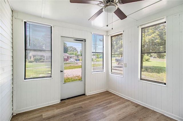1186 Eastview Rd NE, Conyers, GA 30012 - unfurnished sunroom with wood finished floors, plenty of natural light, and wood walls