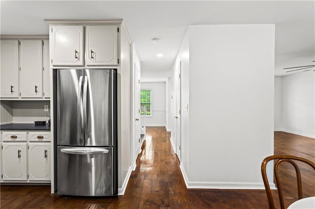 1320 Country Acres Ln, Lawrenceville, GA 30045 - kitchen featuring freestanding refrigerator, dark countertops, dark wood finished floors, recessed lighting, and white cabinets
