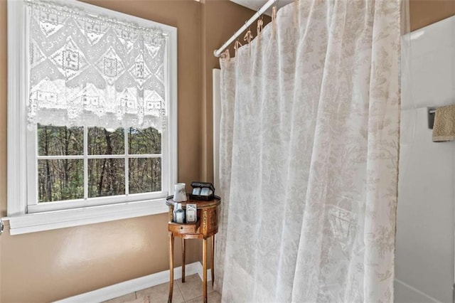 full bathroom with baseboards, curtained shower, and tile patterned floors