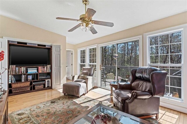 bedroom featuring a ceiling fan, access to outside, vaulted ceiling, and light wood-style flooring