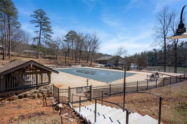 view of swimming pool featuring fence