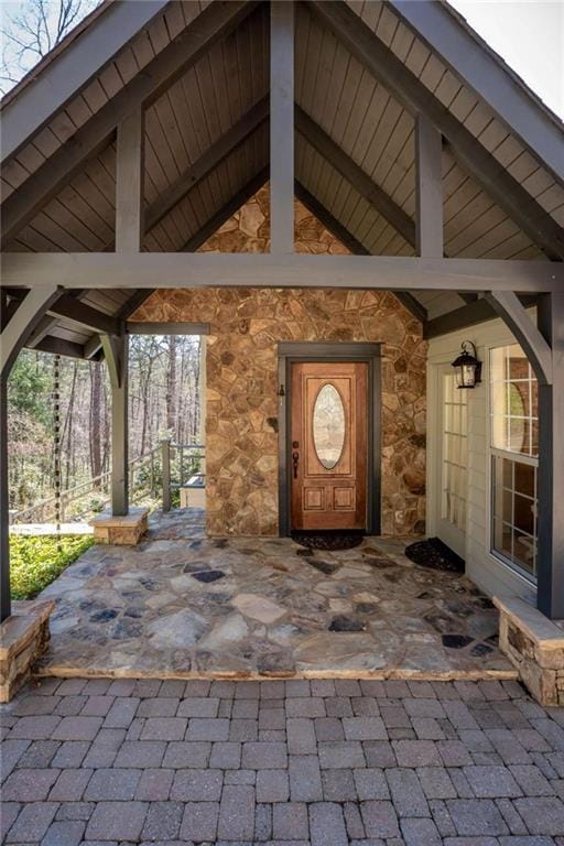 entrance to property featuring stone siding