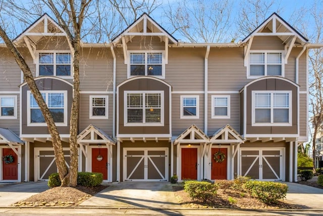 townhome / multi-family property featuring an attached garage and concrete driveway