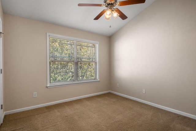 carpeted spare room with a ceiling fan, lofted ceiling, and baseboards