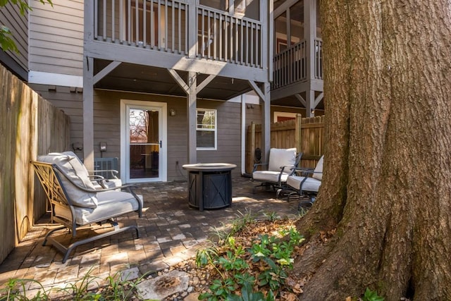 view of patio / terrace featuring fence and a balcony