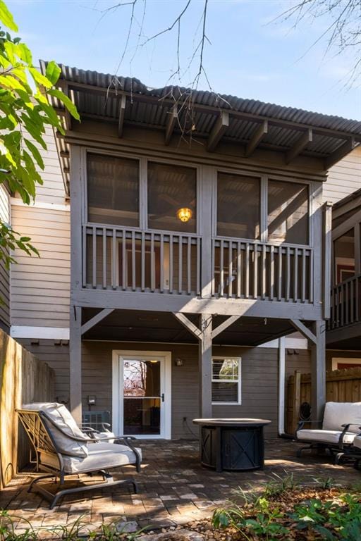 rear view of property with a patio and fence