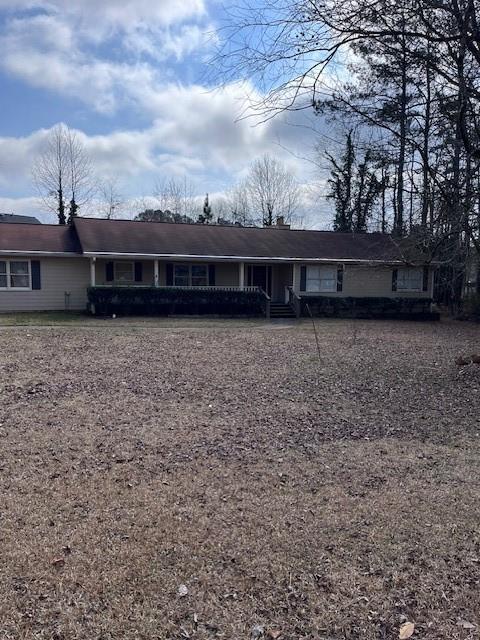 single story home featuring covered porch