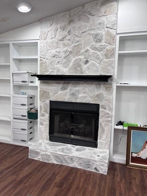 interior details with wood finished floors and a fireplace