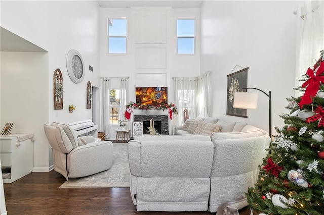 1240 Birchwood Ln, Roswell, GA 30076 - living area featuring a high ceiling, dark wood-style flooring, a fireplace, and baseboards