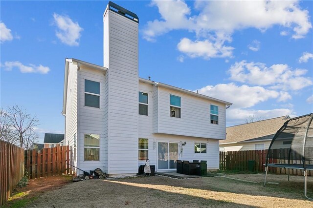 1240 Birchwood Ln, Roswell, GA 30076 - back of house with a trampoline, a chimney, and a patio area