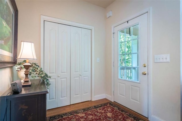 doorway with hardwood / wood-style flooring