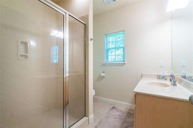 bathroom with tile patterned floors, vanity, toilet, and a shower with shower door