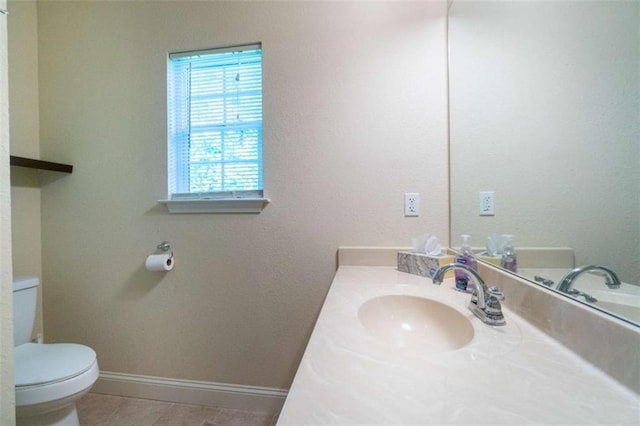 bathroom featuring tile patterned floors, vanity, and toilet