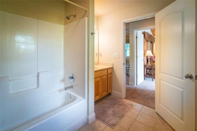 bathroom featuring tile patterned floors, vanity, and washtub / shower combination