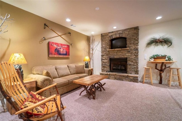 living room featuring carpet and a stone fireplace