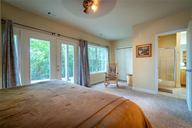 bedroom with ensuite bathroom, access to outside, light colored carpet, ceiling fan, and a closet