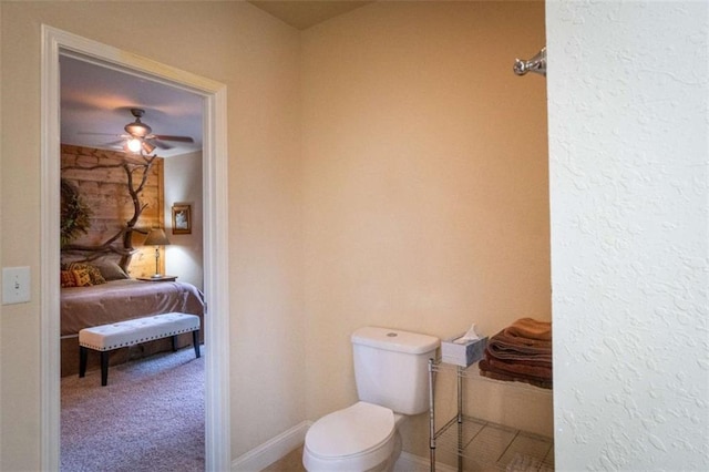 bathroom with ceiling fan and toilet