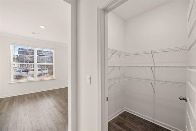 spacious closet featuring dark wood-style floors and visible vents