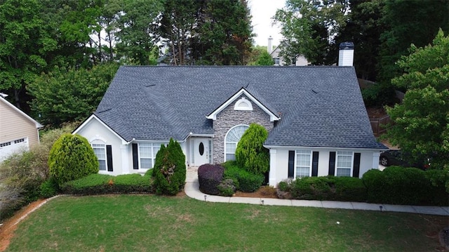 260 Ruby Forest Pkwy, Suwanee, GA 30024 - view of front of house with stone siding, a chimney, and a front lawn