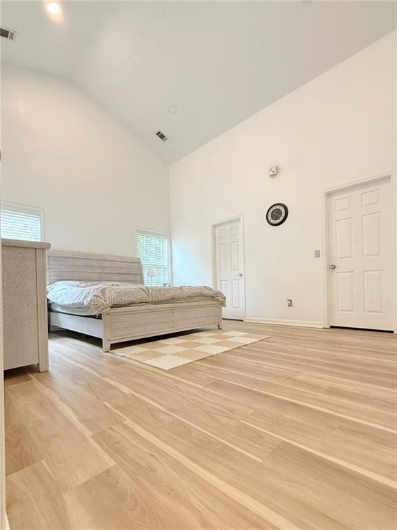 260 Ruby Forest Pkwy, Suwanee, GA 30024 - unfurnished bedroom with high vaulted ceiling, light wood finished floors, and baseboards