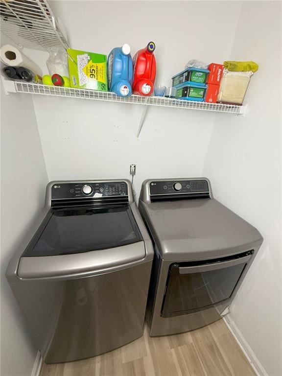 260 Ruby Forest Pkwy, Suwanee, GA 30024 - laundry room with washer and dryer, wood finished floors, and baseboards