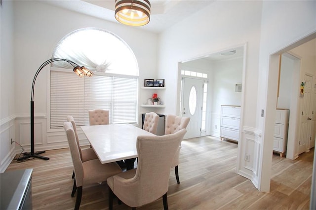 260 Ruby Forest Pkwy, Suwanee, GA 30024 - dining space featuring plenty of natural light, light wood-type flooring, wainscoting, and a decorative wall