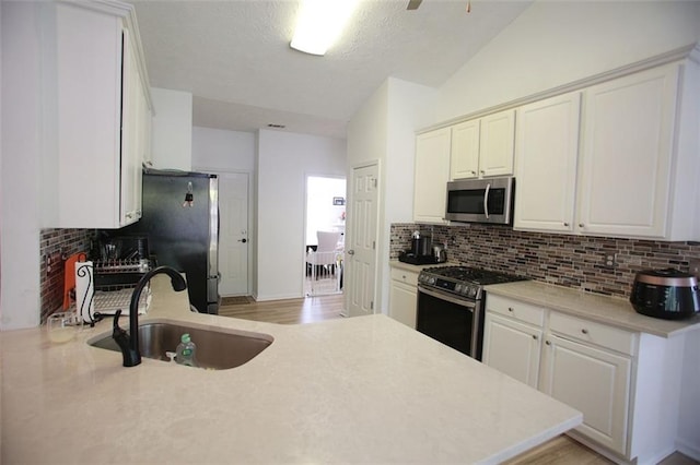 260 Ruby Forest Pkwy, Suwanee, GA 30024 - kitchen featuring stainless steel appliances, a sink, decorative backsplash, and light countertops