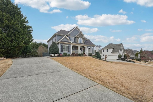 view of front of house with a front yard and covered porch