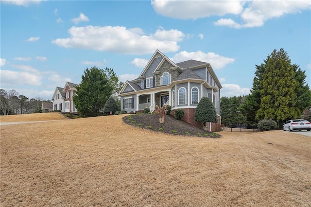 view of front facade with a front lawn and brick siding