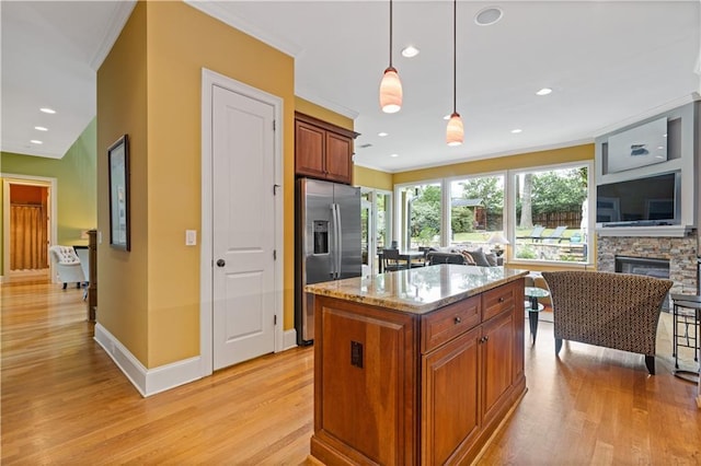 kitchen featuring ornamental molding, light wood-style flooring, and stainless steel fridge with ice dispenser