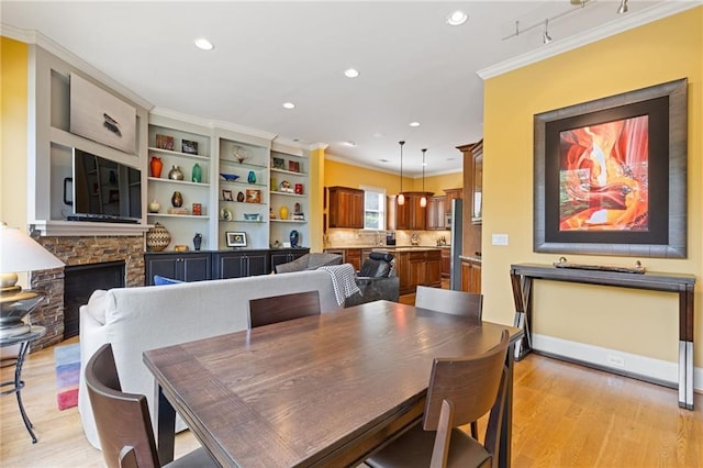 dining area with recessed lighting, ornamental molding, and light wood-style flooring